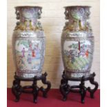 Pair of Cantonese design vases on wooden bases Condition report: see terms and conditions