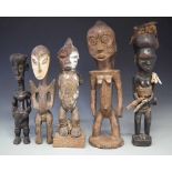 Five figures, carved in Tabwa, Yaka, Lega, and Lulua tribal styles, the Tabwa figure measures 46cm