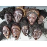 Eight masks carved in Chokwe and similar tribal styles, the largest measures 28cm high All lots in