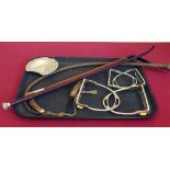 Hunting whip and lash, silver topped riding crop, hoof trimming knife, two sets of stirrups and a