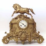 Gilt metal mantle clock with War Horse pediment. Condition report: see terms and conditions