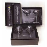 Two pairs of boxed Dartington 'Glitz' Swarovski glasses and a pair of Waterford siren flutes.