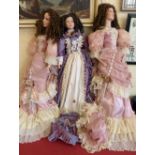 Three large size dolls with stands. Condition report: see terms and conditions
