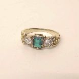 Unmarked gold emerald and diamond three-stone ring. Condition report: see terms and conditions