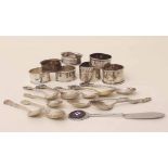 Seven silver napkin ring and various silver and metal souvenir and decorative spoons. Condition