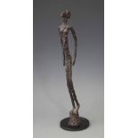 Abdoulaye Guindo (b.1966 - ) bronze sculpture of a standing man in the style of Giacometti measuring