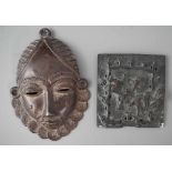 Baule bronze mask together with a small square bronze plaque. The mask measures 11cm high All lots