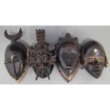 Two Yaure masks, a Senufo mask and a Dan mask, (4) the largest measures 31cm high All lots in this