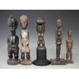 Four figures and a fly wisk or wand, carved in Bangwa, Luba, Baule, and Lobi styles, the tallest