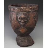 Chokwe drum, carved with a mask and decorated with metal studs, 40cm high All lots in this Tribal