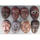 Eight African masks carved in various tribal styles, the largest mask measures 25cm high All lots in