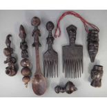 Two combs, three pipes, a rattle, spoon and a mask pendant, carved in Pende, Chokwe, Luba and