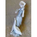 A Lladro Figure of a young lady feeding a goose,