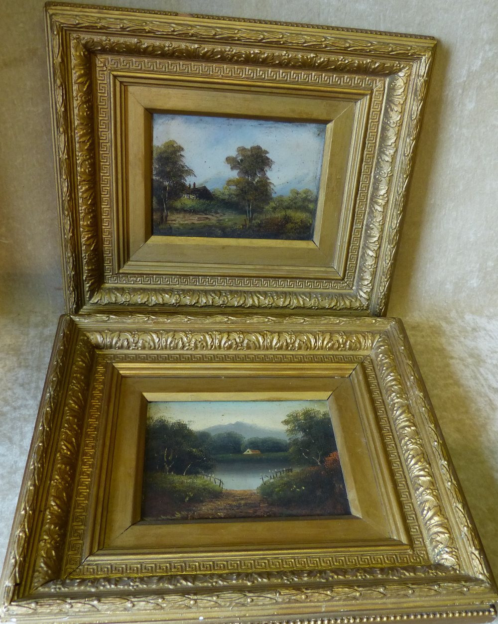 A Pair Oil on Cards depicting cottages in woodland on riverbank in gilt frames, 13.