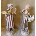 A Pair of Royal Dux Figures of a young boy carrying plate of fruit and a young boy carrying a