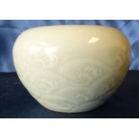 An Oriental small round Brush Pot on pale green ground having wave decoration,