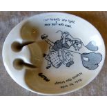 An Ashtead Pottery Oval "David Low" Ashtray on cream and black ground depicting figures and verse,