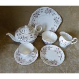 A Royal Standard Tea Service and matching Paragon Teapot on white ground with multicoloured floral