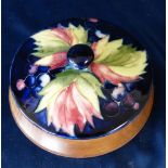 A Moorcroft Round Cover/Lid with later stand on blue ground with multicoloured fruit and leaf