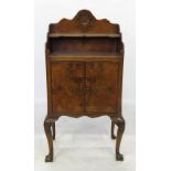 A reproduction walnut bedside cupboard, with bookshelf over,