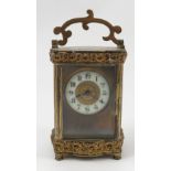 A gilt metal carriage clock, with enamelled chapter ring,