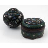 A cloisonne oval covered box, the lid decorated with a bird, the sides decorated in green,