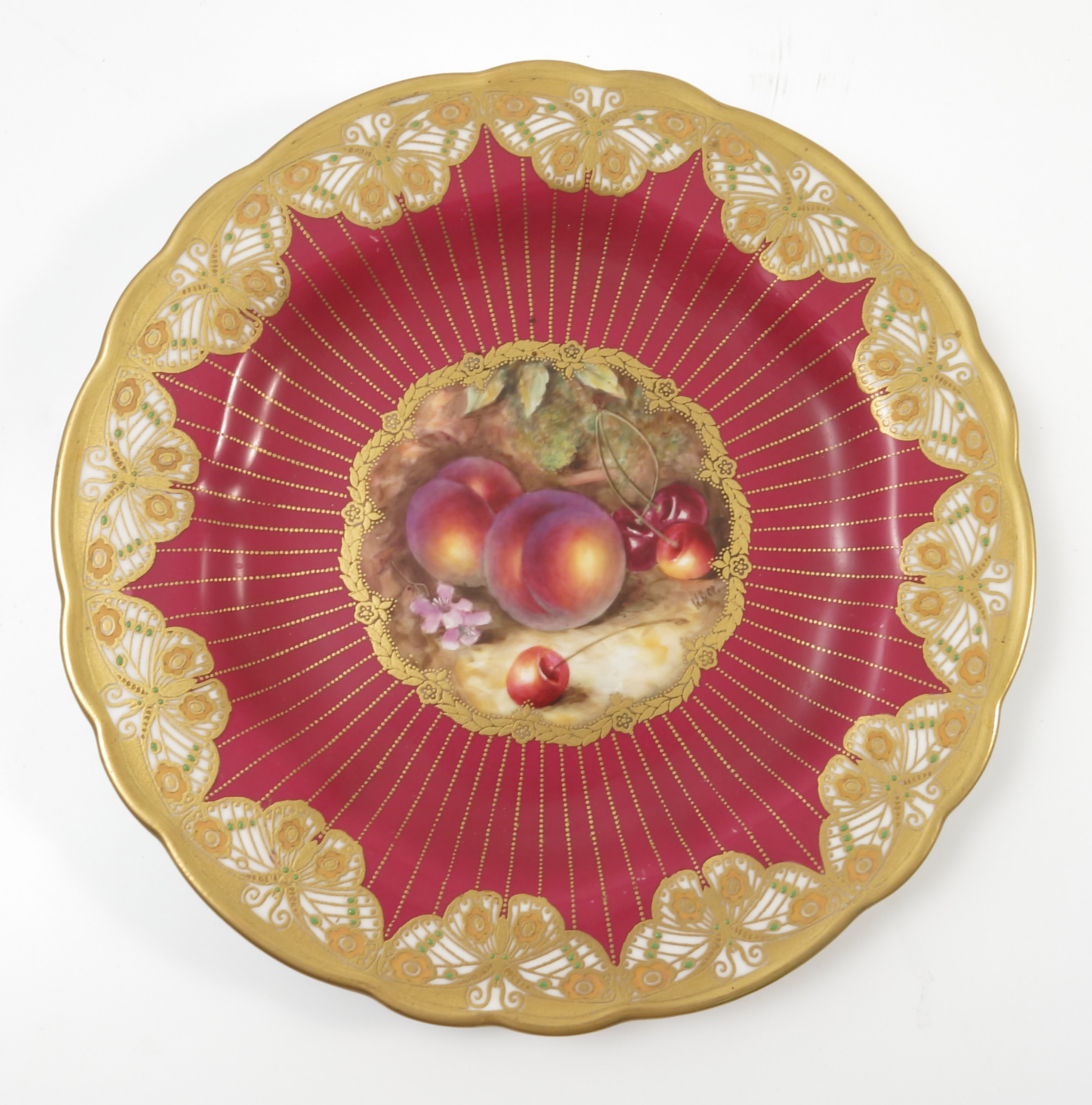 A Royal Worcester cabinet plate, hand painted with fruit to a mossy background, by W Bee,