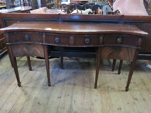 A mahogany sideboard, of serpentine form, with reeded border and an arrangement of drawers,