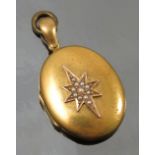 A Victorian oval locket, with an applied pearl set star burst motif, length 4cm including the bale,