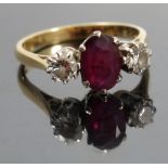 A ruby and diamond three stone ring, stamped '18ct', the oval cut approximately 7.2mmm x 5.