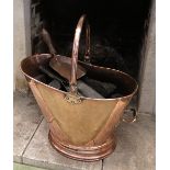 A helmet shaped copper coal bucket, with swing handle,