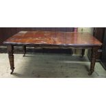 A Victorian mahogany extending dining table, with three additional leaves,