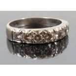 A seven stone diamond half hoop ring, the white mount stamped '18ct',