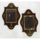 A pair of Empire style mahogany mirrors, mounted with gilt swags and crowns to the border,