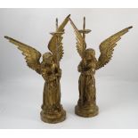 A pair of cast iron pricket candlesticks, formed as angels holding a staff, height 23ins,