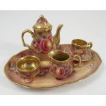 A miniature cabaret set, comprising teapot, milk jug, sugar bowl, cup,