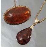 An amber brooch, the wire and corded mount stamped '14ct', length 4.