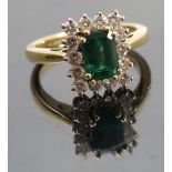 An emerald and diamond 18ct gold ring, the step cut stone measuring approximately 7.