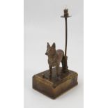 A painted lead model, of a standing dog, mounted on a rectangular metal base with light fitting,