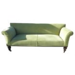 A 19th century sofa, with splayed arms, raised on turned legs,