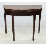 A 19th century mahogany D-shaped folding tea table, with box line edging,