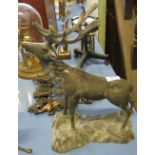 A gilt metal model, of a stag braying, standing on a rocky base, height 14.