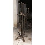 A wrought iron fire set, comprising brush, tongs, shovel and poker,