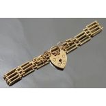 A 9ct gold bracelet, of four bar gate link design, to padlock clasp, weight 14.