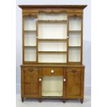 A 19th century light oak dresser, the upper section having two glazed doors, flanking open shelves,