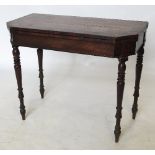 An early 19th century mahogany and rosewood fold over tea table, having cut brass inlay,