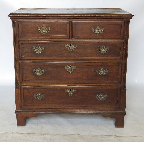 A late 18th century oak chest of drawers, with cross banded top and drawer fronts,