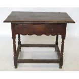 An 18th century oak side table, fitted with a frieze drawer, raised on turned legs,