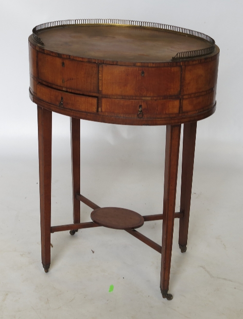 A 19th century circular mahogany side table, with gilt metal gallery to the oval top,