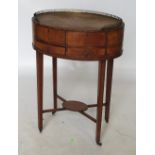 A 19th century circular mahogany side table, with gilt metal gallery to the oval top,